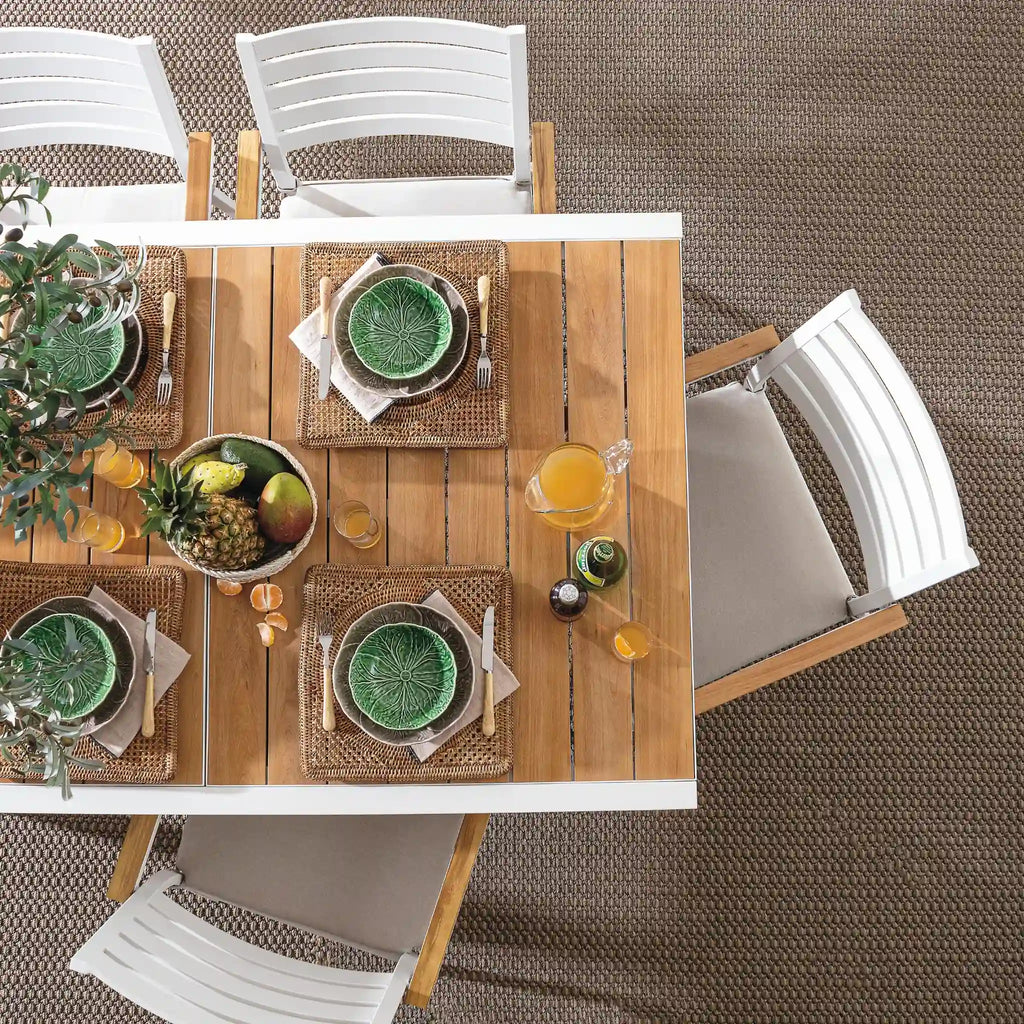 BELMAR Extendable Outdoor Dining Table in White with White Chairs and Fruit on Table