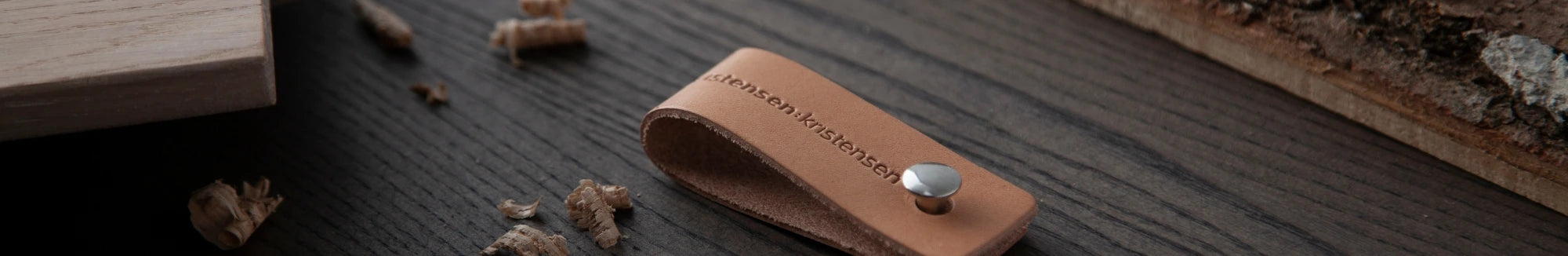 Kritsensen brown leather tag on dark solid wood table