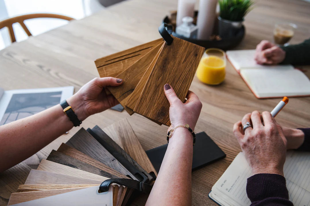 People discussing Wooden Samples from Kristensen Kristensen in our premium furniture showroom