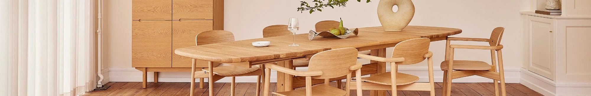 Wooden dining table with chairs in a modern kitchen setting